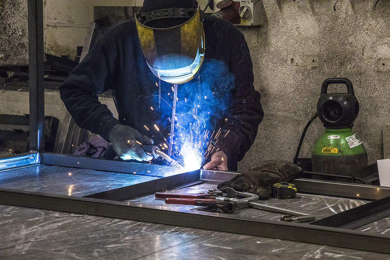 Welding steel to make workbench.