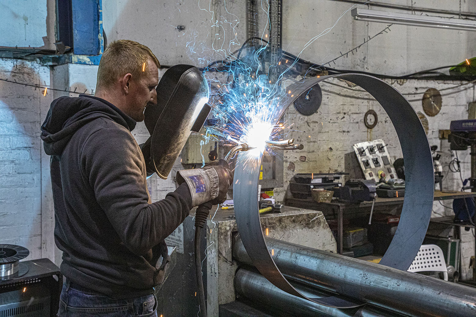 Welding steel to make cylinder.