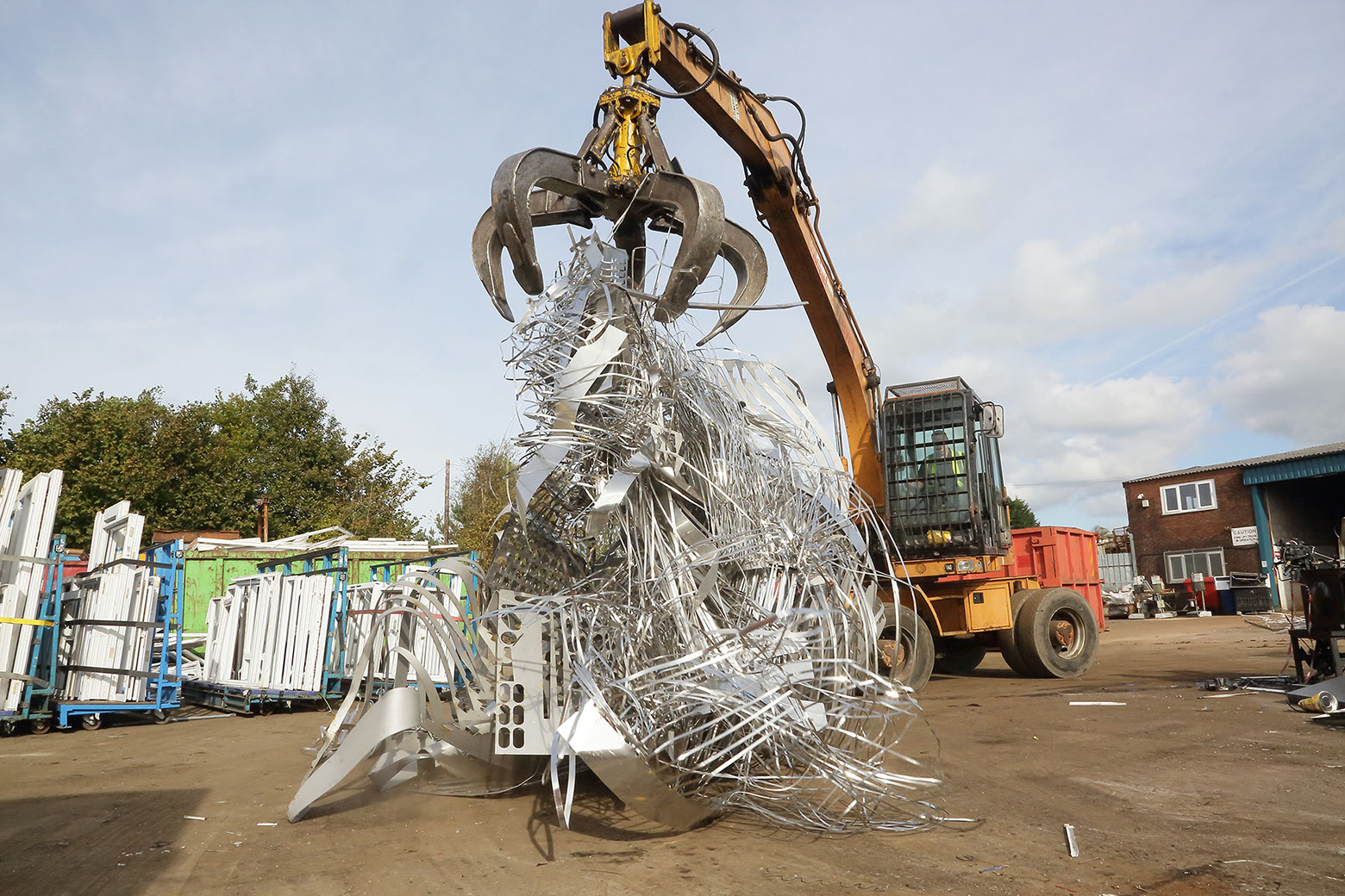 Mechanical Grab dropping scrap stainless steel.